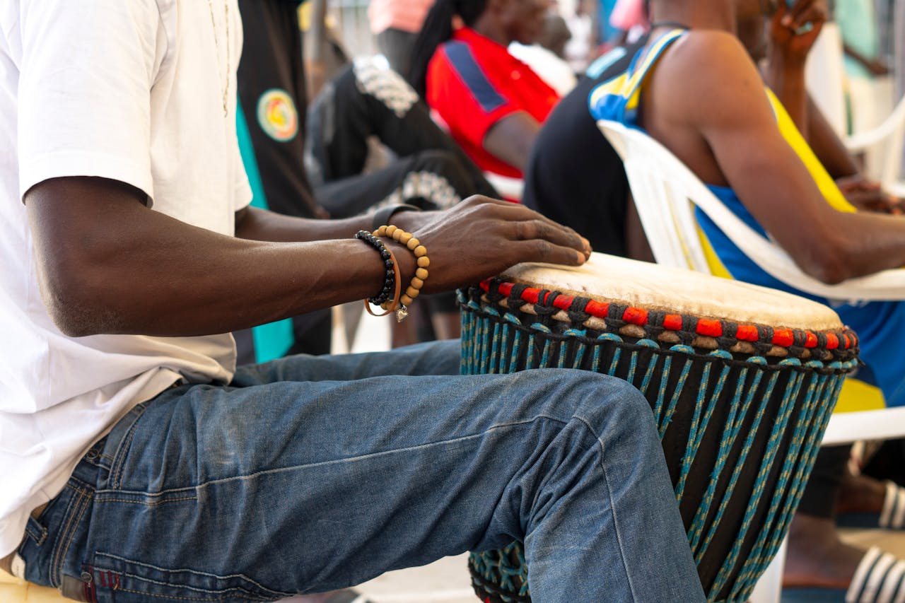 A street musician in Senegal playing a traditional African Djembe drum.